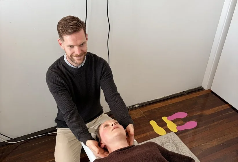 A chiropractor gently adjusting a patient’s neck