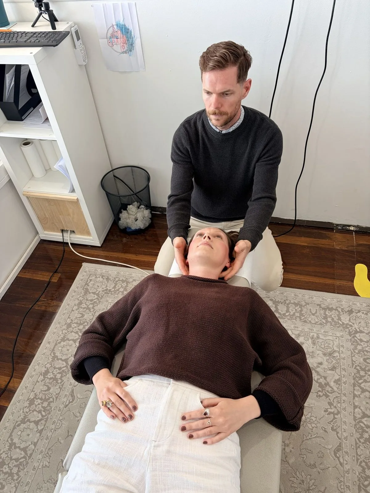 A chiropractor gently assessing a patient’s neck at Body & Soul Chiropractic