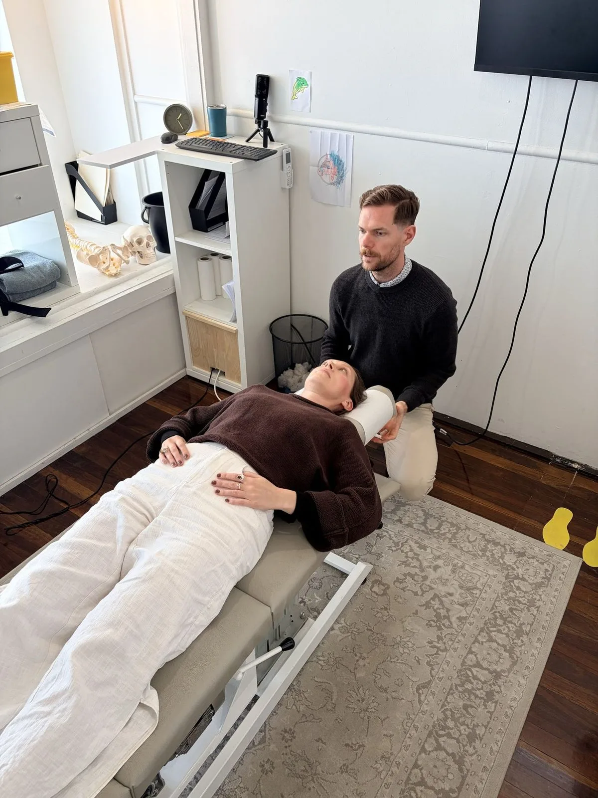 A chiropractor treating a patient lying on a treatment table