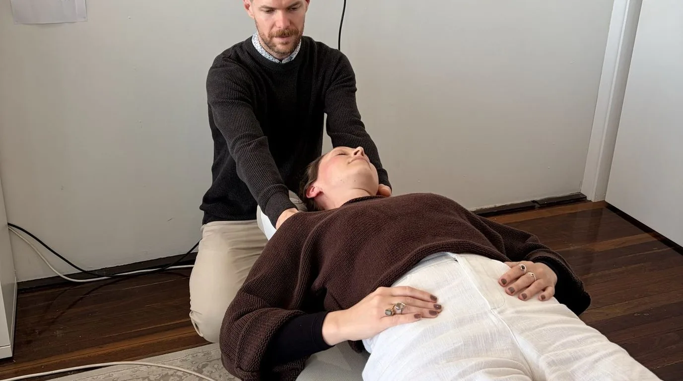 A chiropractor assessing a patient