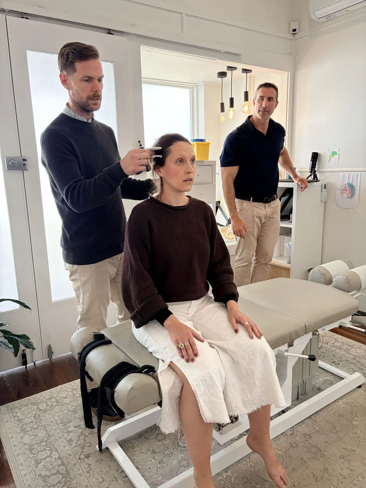 Two chiropractors assessing a patient